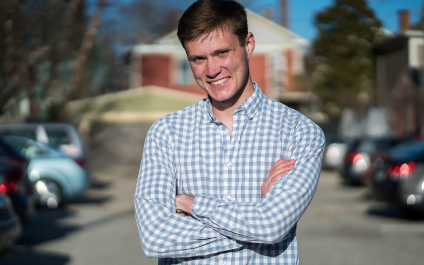 Tom Skipper standing arms crossed in a parking lot