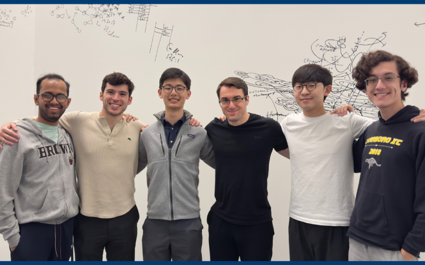 Six students stand in front of a whiteboard