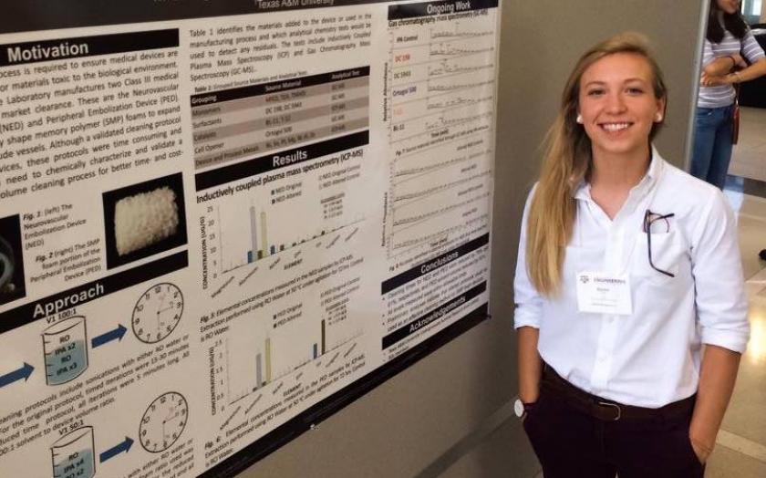 Kenzie Magnan stands next to her poster
