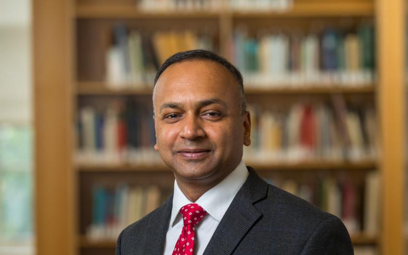 Vikas Srivastava portrait in front of bookshelf
