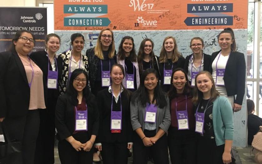 Brown Undergrads attending a conference and career fair take a group photo wearing lanyards