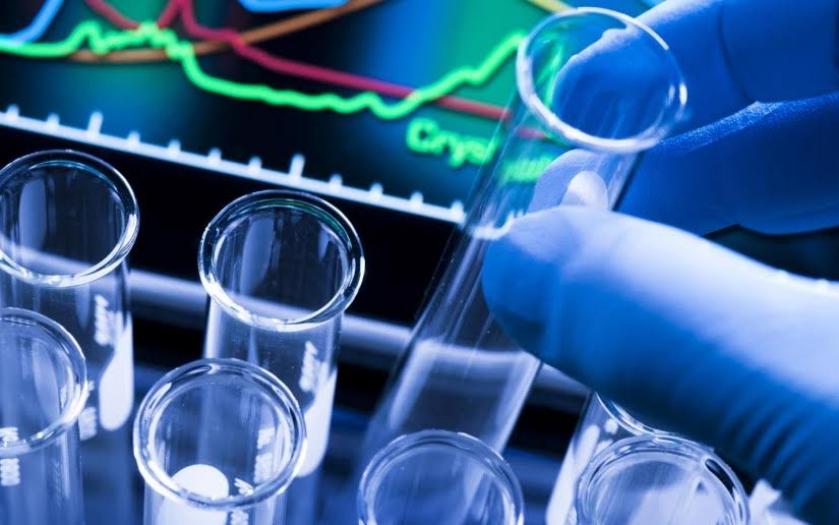 An image of test tubes in front of a statistical line chart