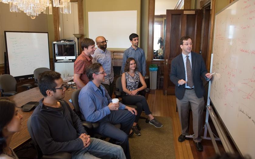 Researchers discussing research in a fancy room