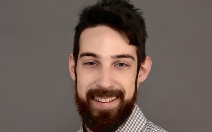 Cameron Baptista headshot on a gray background