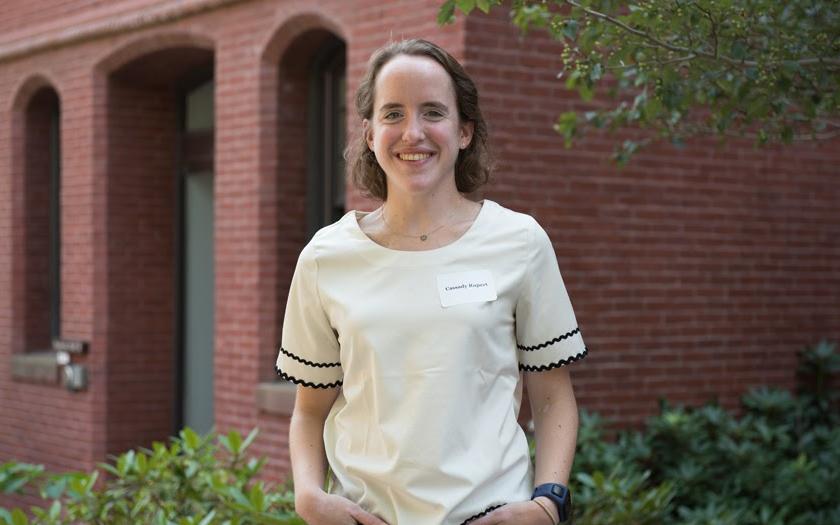 Cassady Rupert posing for a portrait in front of a brick building