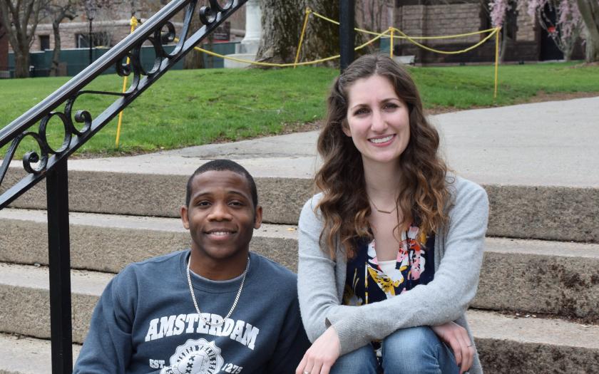 Joshua Daniel and Rachel Deraney sit on steps on campus