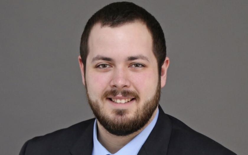 Dominick Calvao headshot with a gray background