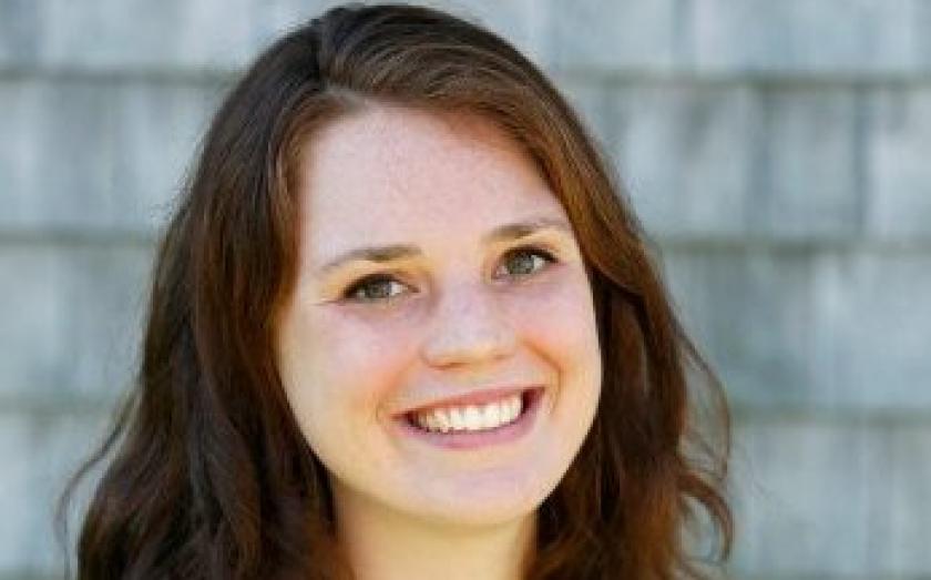 Hayley McClintock portrait in front of a gray wall