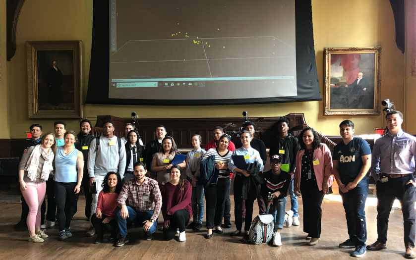 High Schoolers and Researchers posing for a photo in a large hall