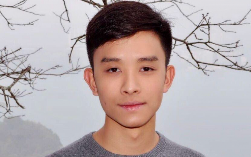 Brian Vuong portrait in front of branches and a white background