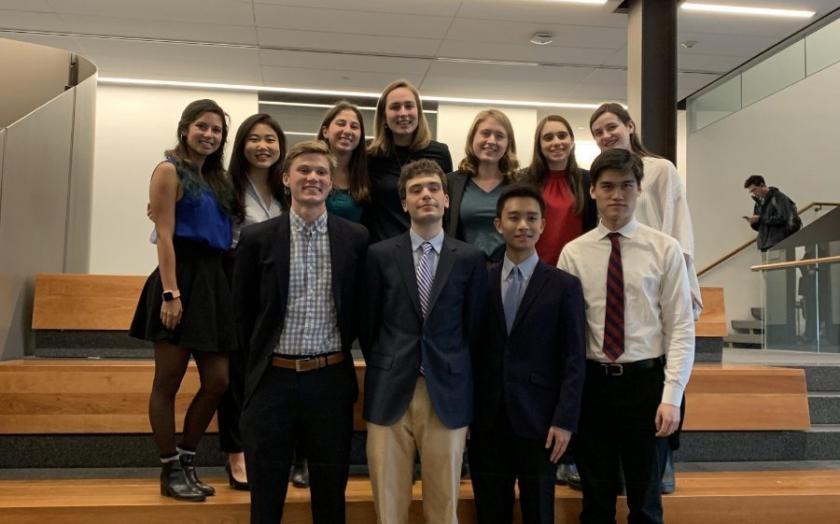 A group of undergraduate students in business attire standing for a group photo