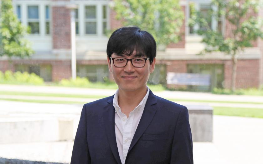 Jonghwan Lee portrait in front of a brick building