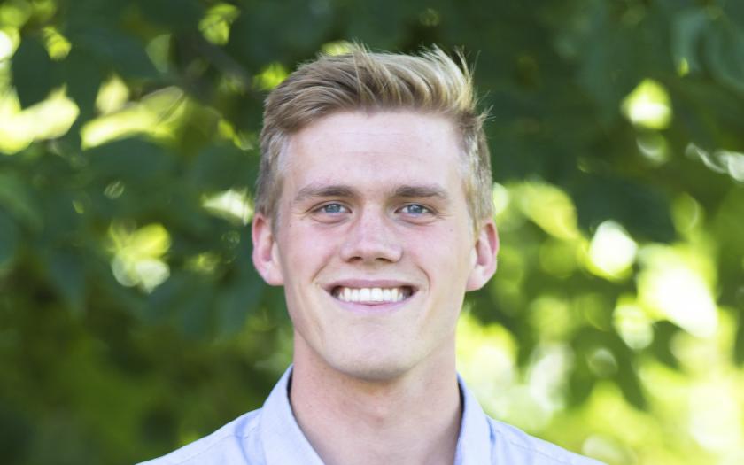 Ryan Brown portrait in front of blurry green foliage