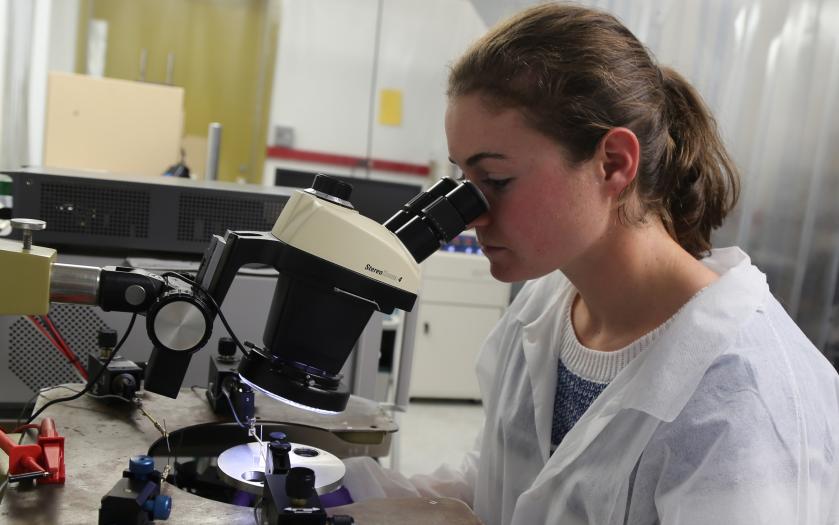 A student looking into a microscope