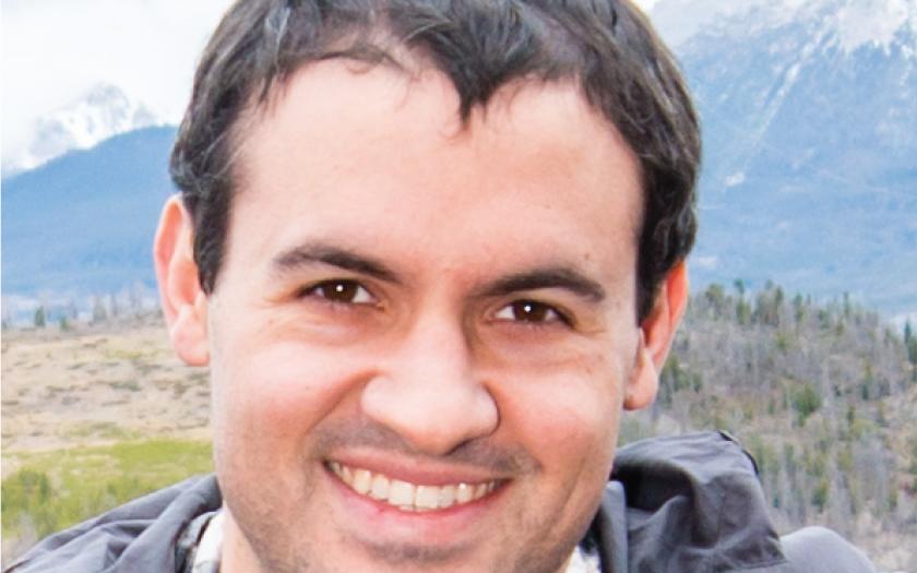 Thomas Valentin close up headshot in front of mountains and forests