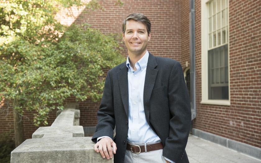 Eric Darling poses for a photo in front of a Brown University building
