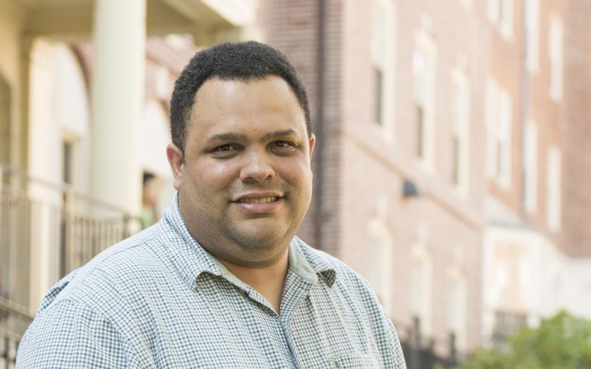 Rafael Gonzalez portrait in front of Brown buildings