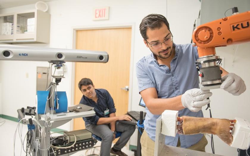 Researchers in a lab with robotics
